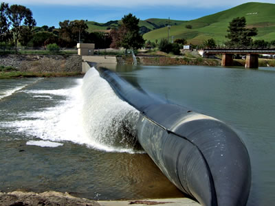 Bookend rubber dam has overflow and there is a mountain on the surrounding.