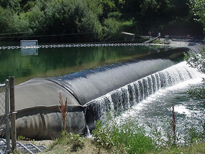Water of upstream flow to downstream passed bookend rubber dam.