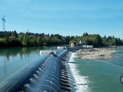 A black disturbed flow rubber dam installed on the top of the concrete slope has beautiful overflow.