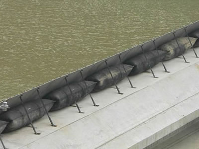 Eight segments shield type rubber dam is on the top of concrete slope.