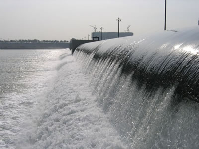 Water is flowed passed black air inflatable rubber dam.