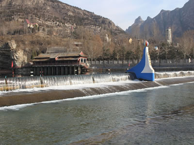 Shield type rubber dam has overflow in the river of scenic spot.