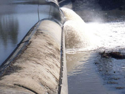 The overflow is flow to downstream by the center of bookend rubber dam.